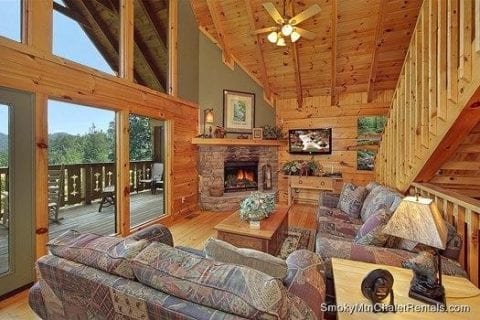 The living room of a Smoky Mountain cabin rental with a fireplace.