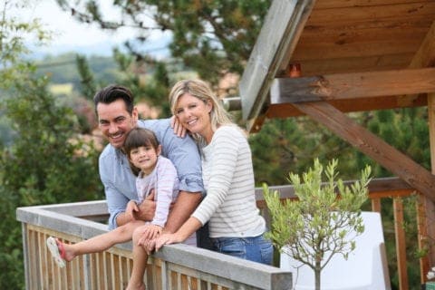 A happy family on the deck of their cabin.