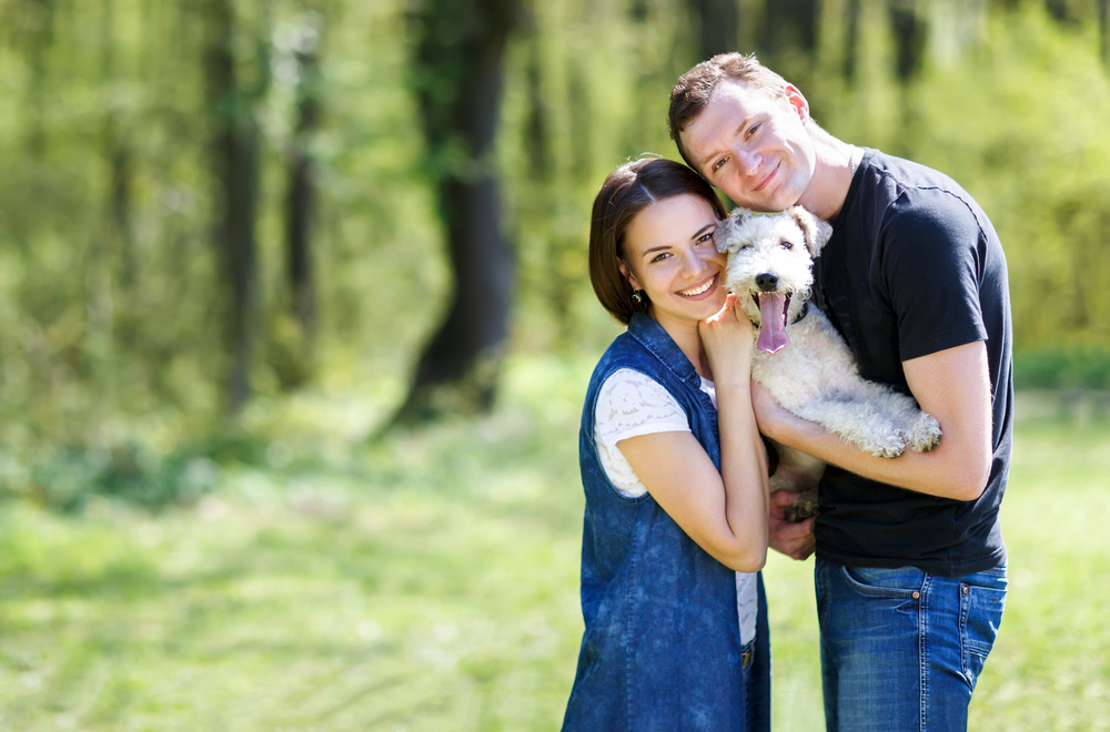 Happy couple and their dog near our pet friendly Smoky Mountain cabins.